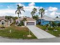 Single-story home with a two-car garage and landscaped yard at 10214 Windsong Rd, Punta Gorda, FL 33955