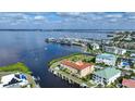 Aerial view of waterfront property with boat slips and nearby marina at 115 Breakers Ct # 111, Punta Gorda, FL 33950