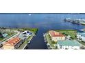 Aerial view showcasing waterfront home and boat at 115 Breakers Ct # 111, Punta Gorda, FL 33950