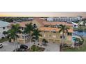 Waterfront building, featuring a copper roof and palm trees at 115 Breakers Ct # 111, Punta Gorda, FL 33950