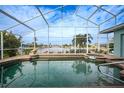 Relaxing screened-in pool and spa overlooking the canal at 1320 Appian Dr, Punta Gorda, FL 33950