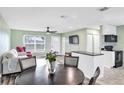 Open concept living and dining area with wood-look floors and modern kitchen at 13366 Bronze Ave, Port Charlotte, FL 33981