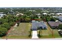 Aerial view showing a single-Gathering home with a large backyard and surrounding houses at 15105 Aldama Cir, Port Charlotte, FL 33981