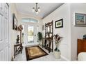 Bright entryway with tiled floor, coat rack, and decorative elements at 15105 Aldama Cir, Port Charlotte, FL 33981
