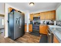 Modern kitchen with stainless steel appliances and wood cabinets at 18235 Avonsdale Cir, Port Charlotte, FL 33948