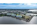 Wide aerial view of waterfront condo building and surrounding area at 200 Harbor Walk Dr # 144, Punta Gorda, FL 33950