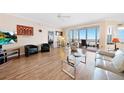 Bright living room with hardwood floors, water views, and comfy seating at 200 Harbor Walk Dr # 144, Punta Gorda, FL 33950