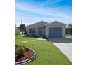 Newly renovated home with a landscaped front yard and attached garage at 20037 Sancraft Ave, Port Charlotte, FL 33954