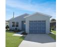 Newly renovated home with a landscaped front yard and attached garage at 20037 Sancraft Ave, Port Charlotte, FL 33954