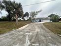 Single story home with a long driveway at 2474 Como St, Port Charlotte, FL 33948
