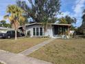 Gray house with palm trees and a walkway leading to the entrance at 2488 Warne St, Port Charlotte, FL 33952