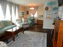 Cozy living room featuring a teal couch and a dark wood floor at 2488 Warne St, Port Charlotte, FL 33952