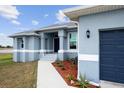 House exterior showcasing entryway, landscaping, and garage at 27 Meadowlark Ln, Placida, FL 33946