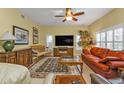 Bright living room with a large TV and comfortable seating at 3112 Club Dr # 124, Port Charlotte, FL 33953