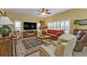 Spacious living room featuring comfortable seating and large TV at 3112 Club Dr # 124, Port Charlotte, FL 33953