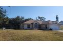 Single story house with a large yard and a two car garage at 4330 Shappell St, Port Charlotte, FL 33948