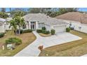 Single-Gathering home with a large driveway and landscaped yard at 5608 New Covington Dr, Sarasota, FL 34233