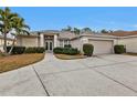 One story house with a two-car garage and manicured lawn at 5608 New Covington Dr, Sarasota, FL 34233