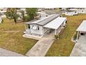 Aerial view of a white mobile home with carport at 6305 Parkview Ct, North Port, FL 34287