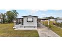 Front view of a white mobile home with carport at 6305 Parkview Ct, North Port, FL 34287