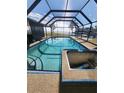 Relaxing screened-in pool and spa area with water views at 258 Beeney Se Rd, Port Charlotte, FL 33952
