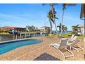 Relaxing pool area with patio furniture, overlooking the canal at 11 Sabal Dr, Punta Gorda, FL 33950