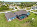 An aerial view showcasing the home's layout, pool, and spacious backyard at 124 Beau Rivage Dr, Rotonda West, FL 33947