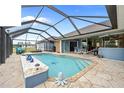 Inviting screened pool area with a spacious patio perfect for relaxation at 124 Beau Rivage Dr, Rotonda West, FL 33947