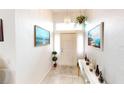 Bright entryway with tiled floors, a console table, and artwork at 13323 Copper Ave, Port Charlotte, FL 33981