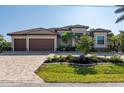 This beautiful home boasts a three-car garage and attractive landscaping at 1406 Mediterranean Dr, Punta Gorda, FL 33950