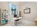 Spacious home office with built-in shelving and large window at 1406 Mediterranean Dr, Punta Gorda, FL 33950