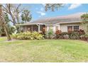 Landscaped backyard with a screened patio at 1433 Red Oak Ln, Port Charlotte, FL 33948