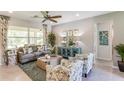 Living room with gray couch, blue cabinet, and coastal decor at 14386 San Domingo Blvd, Port Charlotte, FL 33981