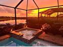 Relaxing spa and pool area with a stunning sunset view at 15169 Spanish Point Dr, Port Charlotte, FL 33981