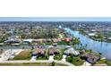 Wide aerial showcasing the property's waterfront location and neighborhood at 15706 Viscount Cir, Port Charlotte, FL 33981