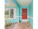 Red front door entry with teal colored walls at 1638 Viscaya Dr, Port Charlotte, FL 33952