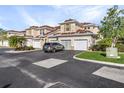 Two-story townhome with attached garage and a car parked in driveway at 240 W End Dr # 212, Punta Gorda, FL 33950