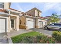 Tan two-story townhome with attached two-car garage and landscaping at 240 W End Dr # 212, Punta Gorda, FL 33950