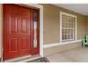 Red front door with sidelights and American flag decal at 2411 Altoona Ave, North Port, FL 34286