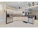 Spacious kitchen with stainless steel appliances and white cabinets at 2411 Altoona Ave, North Port, FL 34286