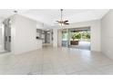 Bright living room with tile floors and sliding glass doors leading to the backyard at 24434 Rio Togas Rd, Punta Gorda, FL 33955