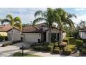 Beautiful house featuring a two-car garage and lush landscaping at 2476 Daisy Dr, North Port, FL 34289