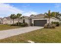 One-story house with a two-car garage and mature landscaping at 25339 Alicante Dr, Punta Gorda, FL 33955