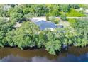 Waterfront property with a private pool and lush landscaping at 27300 San Carlos Dr, Punta Gorda, FL 33983