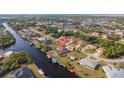 Aerial view showing home's location on a canal with neighborhood context at 4122 Library St, Port Charlotte, FL 33948