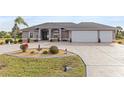 Exterior of two-story house with two-car garage and landscaped yard at 4122 Library St, Port Charlotte, FL 33948