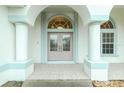 Double-door entry with arched window and decorative glass at 437 Loveland Blvd, Port Charlotte, FL 33954