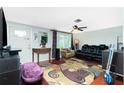 Living room with leather couch, wood floors, and a large TV at 4657 Nele St, North Port, FL 34287