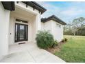 Modern front door with glass panels and sidelights at 5435 Montego Ln, Port Charlotte, FL 33981