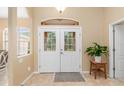 Bright and airy foyer with double doors and tile flooring at 5465 Trumpet St, North Port, FL 34291